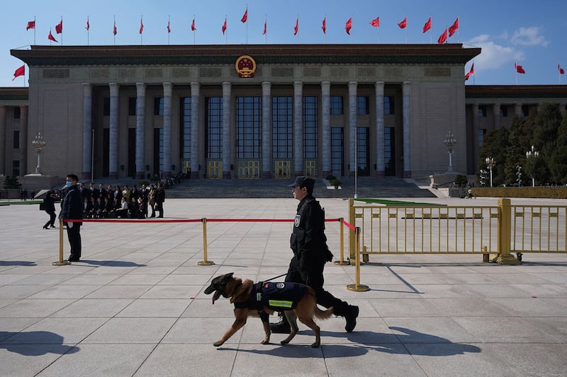 2024年3月11日，中国北京，人大会闭幕前，警察携警犬在人民大会堂外巡逻。（美联社）