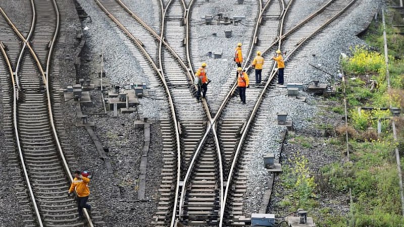 Workers inspect railway tracks that are part of China's Belt and Road freight rail route linking the Chinese city of Chongqing to Duisburg in western Germany, at the Dazhou railway station in southwestern China's Sichuan province, March 14, 2019.