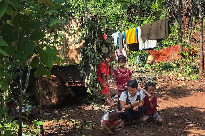 A family takes refuge in a jungle area in Demoso, Kayah state, after fleeing from fighting between the Myanmar military and members of the People's Defence Force (PDF), June 3, 2021. STR / AFP