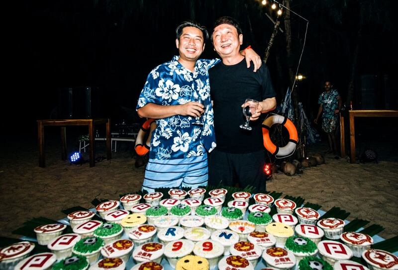 Rithy Samnang, left, and Xu Aimin have fun at the beach birthday party Samnang threw for himself on the island of Koh Smach. Credit: MAX Media