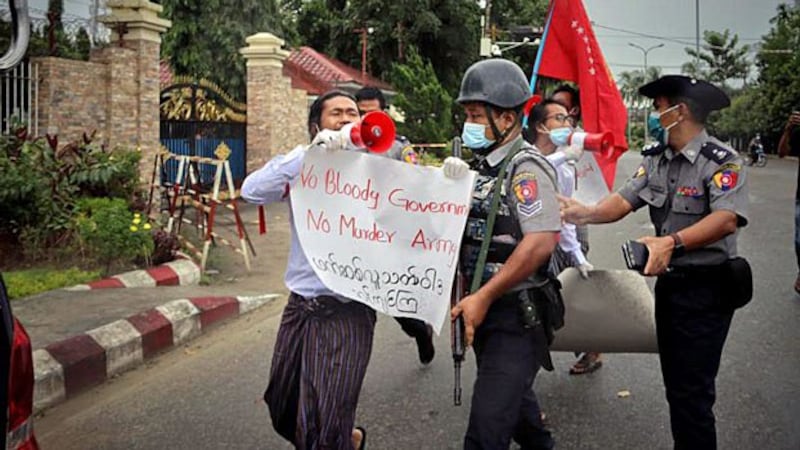 Police arrest three students protesting against the armed conflict in western Myanmar's Rakhine state, in the state capital Sittwe, Sept. 11, 2020.