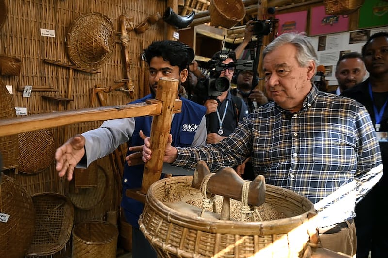 U.N. Secretary-General António Guterres observes a traditional tool used by Rohingya to thresh rice, March 14, 2025.