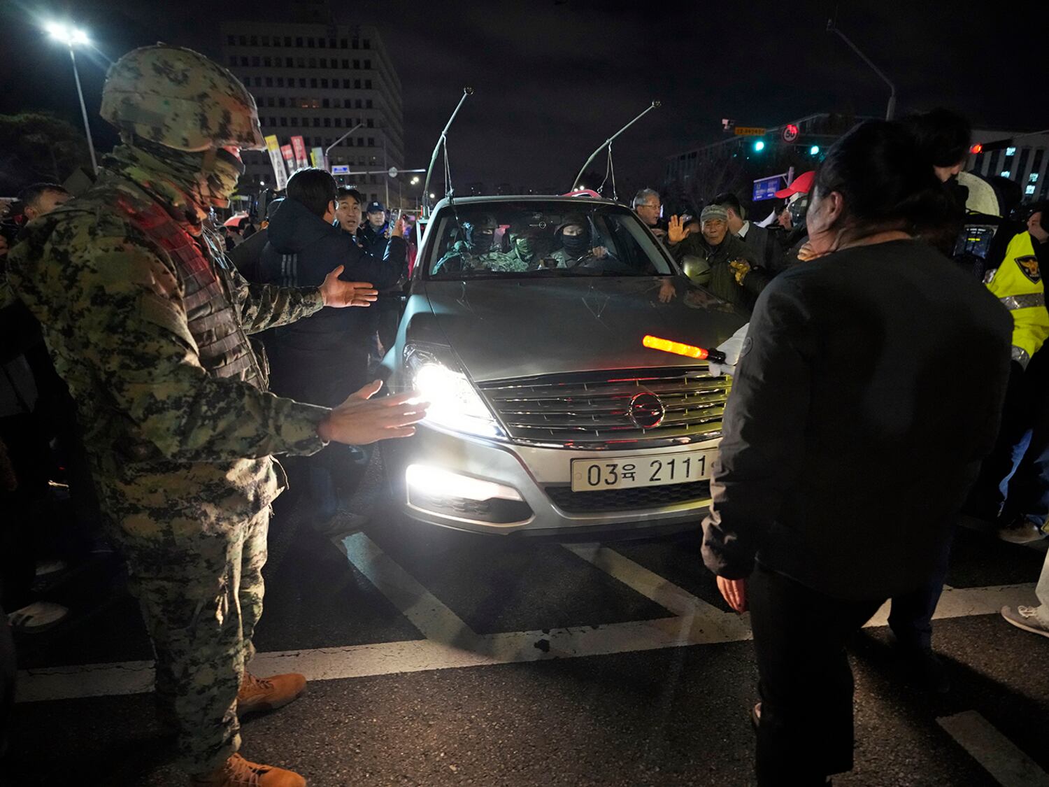 People block a martial law vehicle as they gather to demand South Korean President Yoon Suk Yeol to step down in front of the National Assembly in Seoul, Dec. 4, 2024.