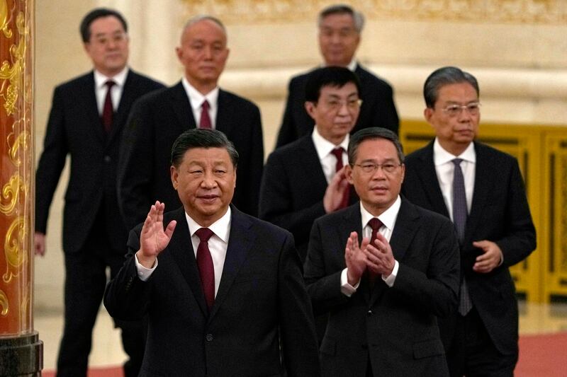 New members of the Politburo Standing Committee, front to back, President Xi Jinping, Li Qiang, Zhao Leji, Wang Huning, Cai Qi, Ding Xuexiang, and Li Xi arrive at the Great Hall of the People in Beijing, Sunday, Oct. 23, 2022. (AP Photo/Ng Han Guan)