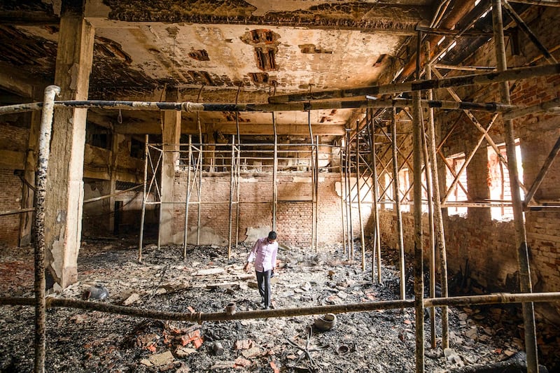 A man walks inside a burnt studio of the state-owned Bangladesh Television in Dhaka, Bangladesh, July 24, 2024. (Rajib Dhar/AP)