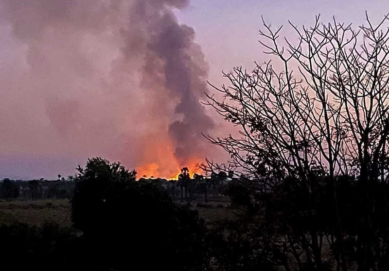 A building on fire at Pan village during the Jan. 31, 2022, arson attack. (Credit: Citizen journalist)