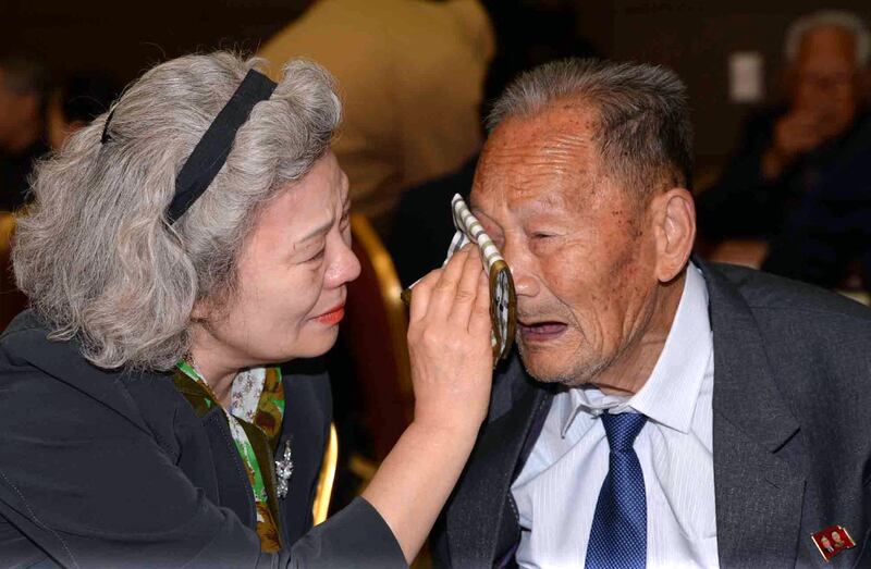 South Korean Lee Jeong-Suk (L), 68, wipes the tears of her North Korean father Ri Heung-Jong (R), 88, as they bid farewell following their three-day separated family reunion meeting at the Mount Kumgang resort on the North’s southeastern coast on Oct. 22, 2015.