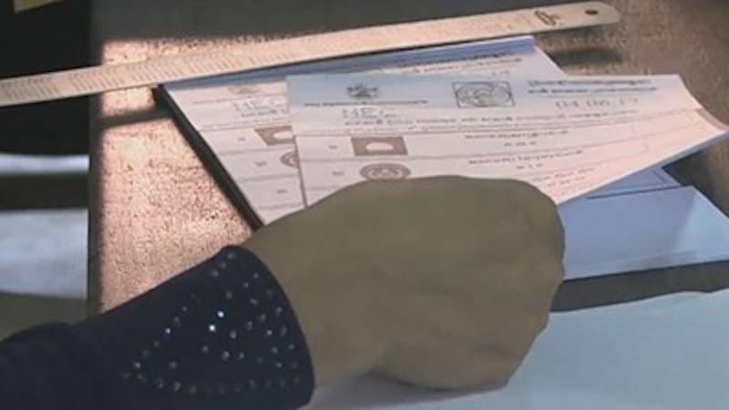 An election official prepares a ballot at a polling station, June 4, 2017. Credit: RFA