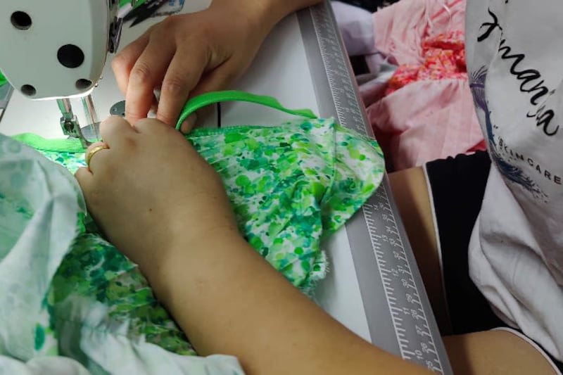 A worker sews a garment in this undated photo from a factory in Guangzhou.