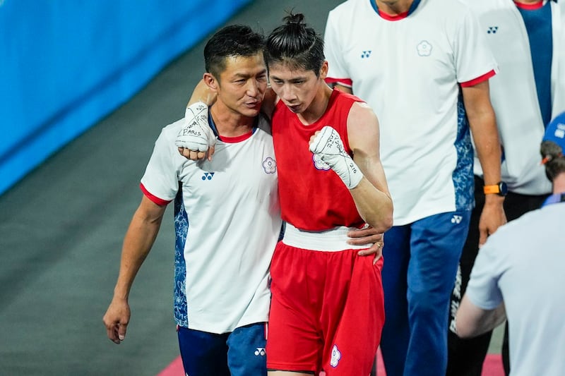 Taiwan's Lin Yu-ting celebrates with a coach after defeating Turkey's Esra Yildiz in their women's 57 kg semifinal boxing match at the 2024 Summer Olympics, Aug. 7, 2024, Paris, France. (John Locher/AP)