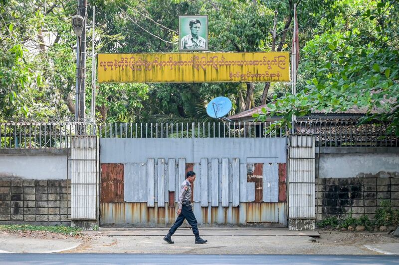 A police officer walks outside the entrance of the family house of detained Myanmar civilian leader Aung San Suu Kyi in Yangon, Myanmar, March 20, 2024. (AFP)