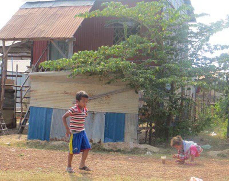 Children play in front of homes at the resettlement site in Phnom Bat, March 2014. Photo credit: RFA.