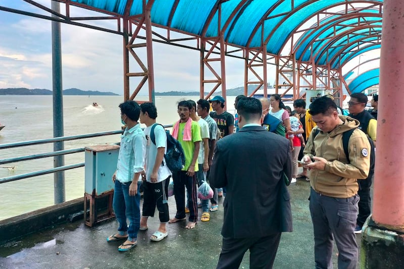 Myanmar citizens who will be repatriated to Kawthoung, Myanmar, are gathered at the port for deportation in Ranong, Thailand, Aug. 7, 2024. (Ranong Immigration Office via Facebook)