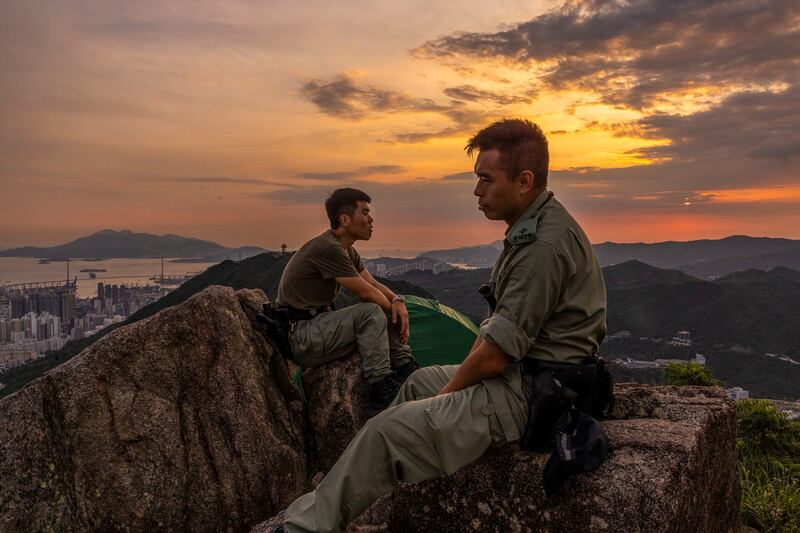 Police stand guard on top of Lion Rock mountain in anticipation of people gathering to mark the fourth anniversary of the city's mass protests in Hong Kong, June 12, 2023. (Louise Delmotte/AP)