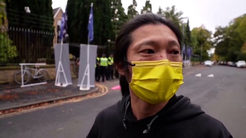 A protester who identified himself only as Bob was dragged into the Chinese consulate grounds where he was held to the ground and beaten by four people, in Manchester, Britain October 16, 2022. Credit: Screenshot from Reuters video