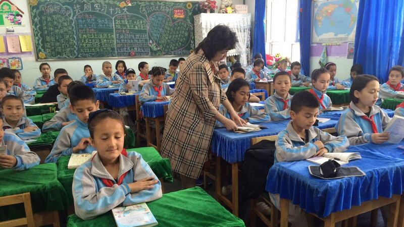 Qelbinur Sidik teaches elementary school children in Urumqi in an undated photo.