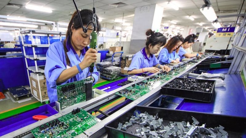 Women work on the production line manufacturing electronic keyboards at a factory of the Tianjin Yamaha Electronic Musical Instruments Co. in Tianjin, China, Dec. 4, 2018. 