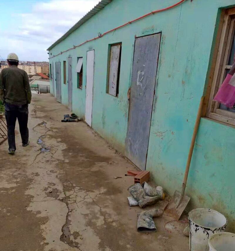 A Chinese worker walks by a building at a construction site in Algeria's Souk Ahras province. Credit: A Chinese worker.