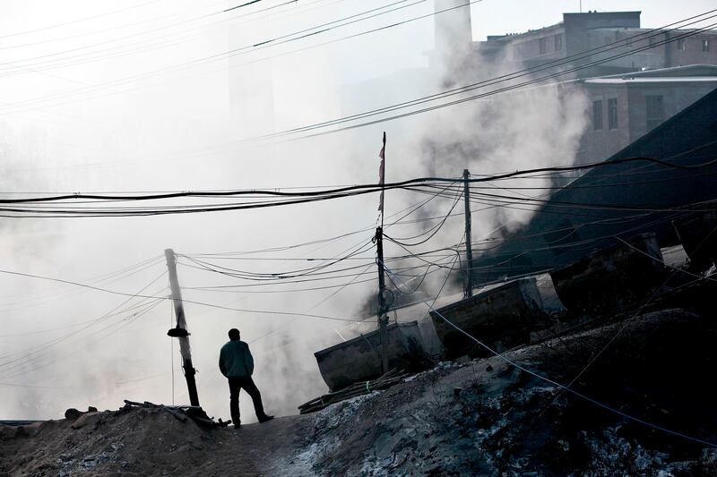 A mineworker stands near a gas explosion site at the Xinxing Coal Mine in Hegang, Heilongjiang Province, Nov. 23, 2009. Credit: Reuters