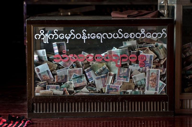 Myanmar Kyat notes are seen in a donation coffer at a Buddhist pagoda in Yangon, April 17, 2017. (Roberto Schmidt/AFP)