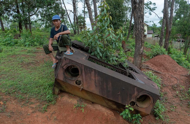 A Lao man sits on the remains of a Soviet-era tank in Xieng Khouang, northeastern Laos, June 27, 2023. Credit: Tran Viet Duc/RFA