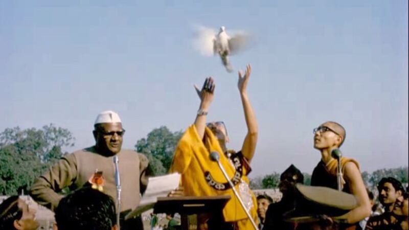 The Dalai Lama lifts a dove into the air in the trailer of 'Wisdom of Happiness,' a documentary that features rare archival material of the Tibetan Buddhist spiritual leader's early life. (Image from 'Wisdom of Happiness' trailer via YouTube)