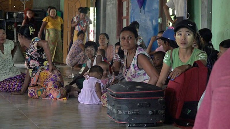 Villagers who fled their communities amid armed conflict in Maungdaw township sit on the floor of a Buddhist monastery in which they took shelter in Sittwe, capital of western Myanmar's Rakhine state, July 15, 2020.