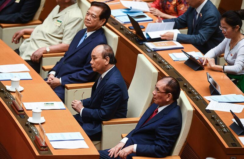 Vietnam's former President Nguyen Xuan Phuc, center, attends the opening of the National Assembly's summer session in Hanoi on May 22, 2023. (Nhac Nguyen/AFP)