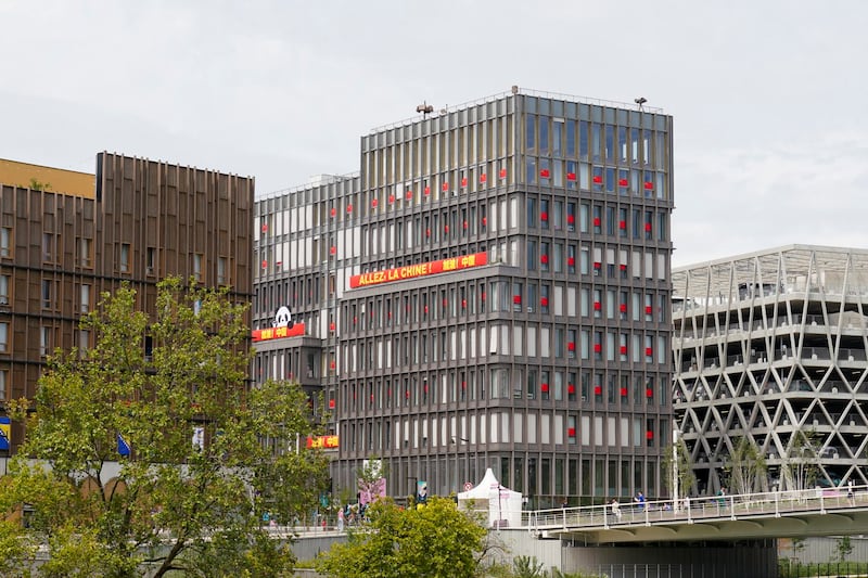 Chinese national flags and slogans are displayed on the building used by the Chinese Olympic team in Paris, July 24, 2024. (RFA)