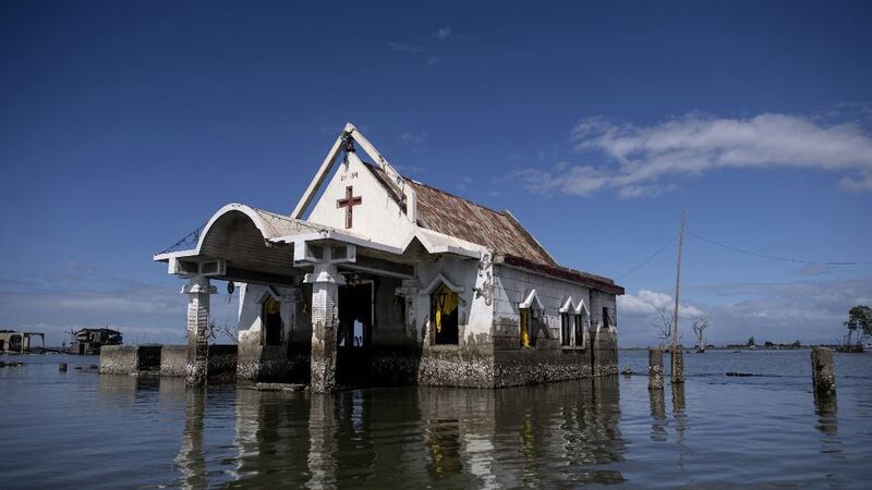 A chapel and intruding waters in Bulacan, a region in the Philippines that has sunk 1.5-2.4 inches a year since 2003.