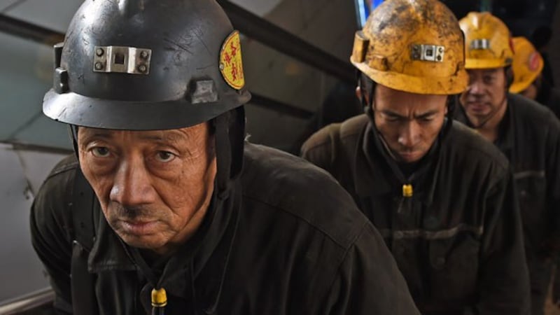 Coal miners leave a mine after their underground shift ends in Datong, northern China's Shanxi province, Nov. 20, 2015.