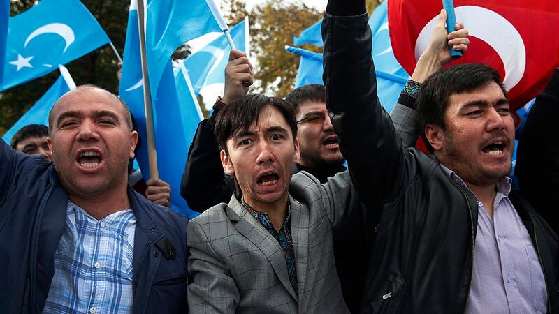 Members of the Uyghur community in Turkey carry flags and chant slogans during a protest in Istanbul, Nov. 6, 2018.