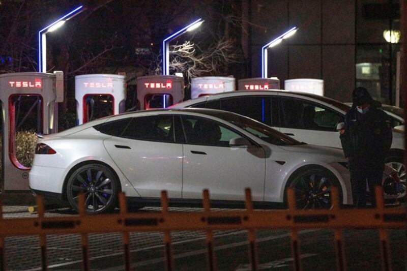 Electric cars recharge their batteries at Tesla charging stations in Beijing, Jan. 4, 2022. (Ng Han Guan/AP)