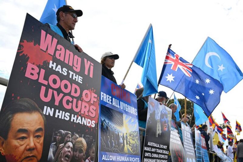 Protesters take part in a rally organized by the Alliance for Victims of the Chinese Communist Regime to coincide with the visit to Australia by Chinese Foreign Minister Wang Yi at Parliament House in Canberra, March 20, 2024. (Lukas Coch/AAP via Reuters)