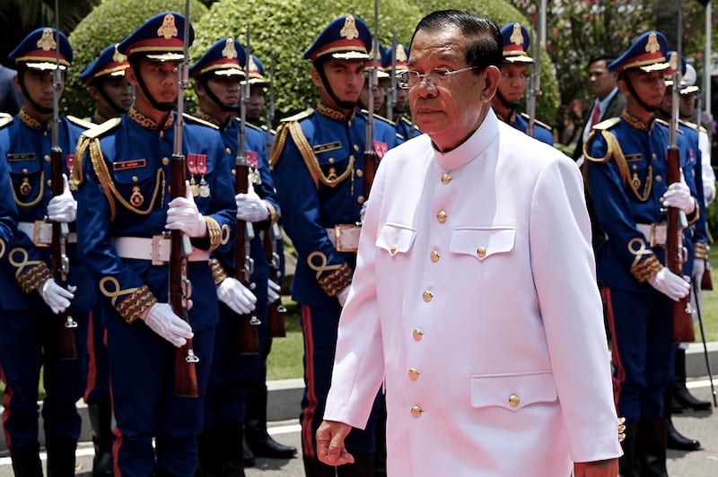 Cambodia's Senate President Hun Sen walks past an honor guard in Phnom Penh on April 3, 2024.