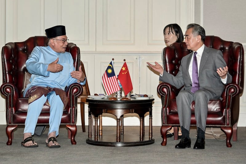 Malaysian Prime Minister Anwar Ibrahim (left) talks with Chinese Foreign Minister Wang Yi at the Eastern & Oriental Hotel in Georgetown on Penang island, Malaysia, Aug. 11, 2023. [Handout Prime Minister's Department of Malaysia]