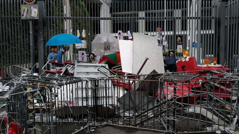 垃圾清洁工在清理抗议者冲入香港政府建筑后留下的垃圾。（美联社）