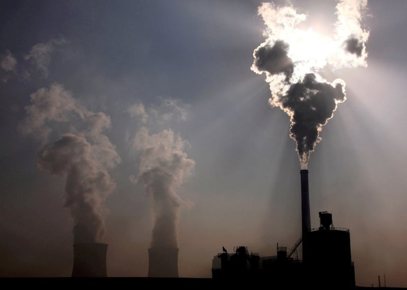 A coal-burning power plant can be seen behind a factory in the city of Baotou, in China's Inner Mongolia Autonomous Region, Credit: Reuters