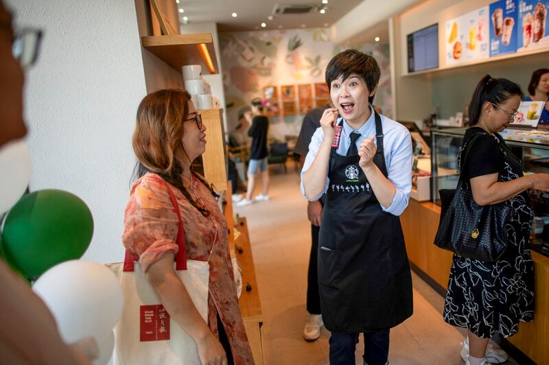 Chen Yuanyuan, center, communicates with a hearing-impaired customer at a Starbucks cafe in Wuhan, central China's Hubei Province, June 16, 2024. (Wu Zhizun/Xinhua via Getty Images)