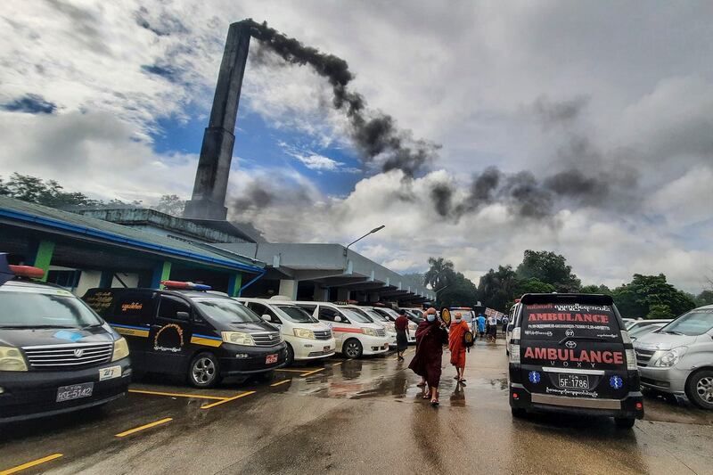 004Monks seen after funeral sermon at Yayway crematorium in Yangon as smoke rising from chimney on Jul 12_Credit Bo Sein.jpeg