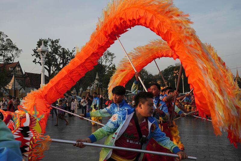 Ethnic Chinese people in Cambodia perform a dragon dance on Jan. 28, 2025, in front of the royal palace in Phnom Penh.