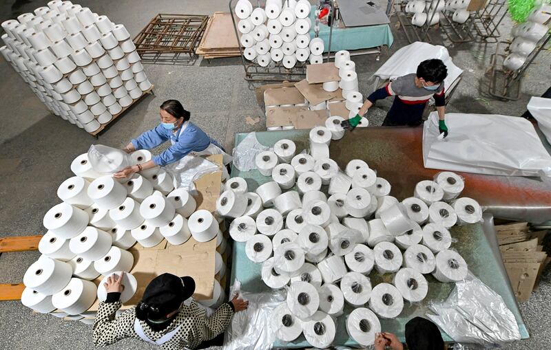 Workers are seen on the production line at a cotton textile factory in Korla, Xinjiang Uighur Autonomous Region, China April 1, 2021. (cnsphoto via Reuters)