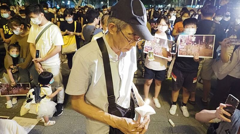 Former Hong Kong bookseller Lam Wing-kei, who has re-opened a bookstore in Taiwan after he and four colleagues were detained by Chinese police for books they sold, joins a candlelight vigil in Taipei for the 31st anniversary of the 1989 Tiananmen massacre, June 4, 2020.