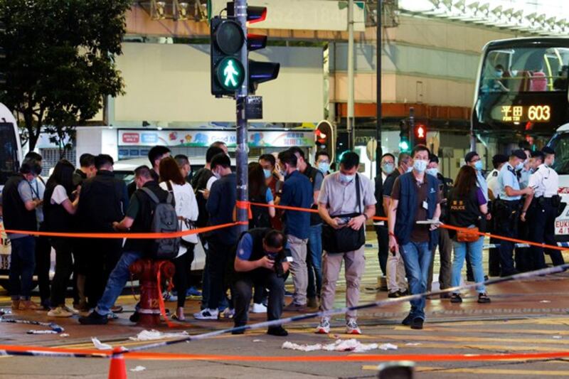 A police officer takes photos at the site where Leung Kin-fai stabbed a police officer in Causeway Bay in Hong Kong, July 1, 2021. Credit: Tyrone Siu/Reuters