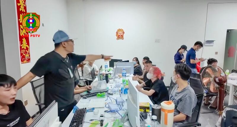 A raid of what appears to be a call center is shown in a still image captured from video broadcast by Lao Public Security Television, Aug. 9, 2024. (laopstv via Facebook)