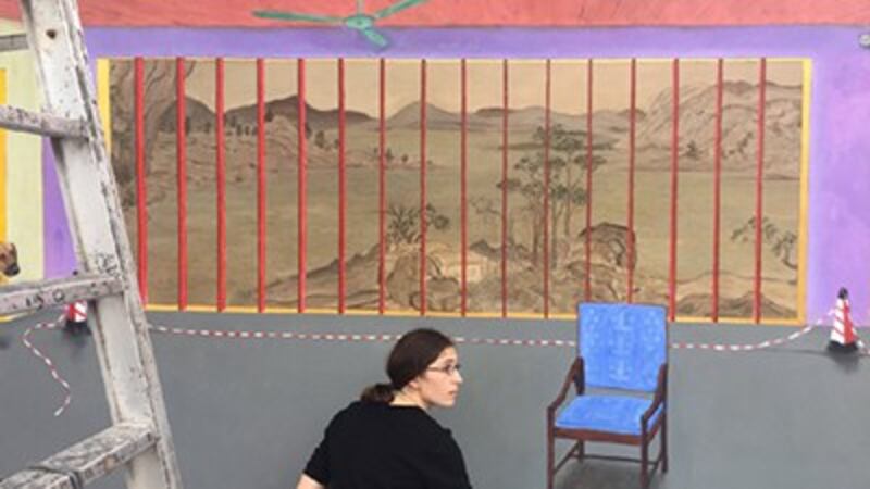 Hu Jiamin's wife, Marine Brossard, prepares her husband's painting for exhibition in Shenzhen, in an undated photo. Credit: Free Liu Xiaobo's Twitter feed