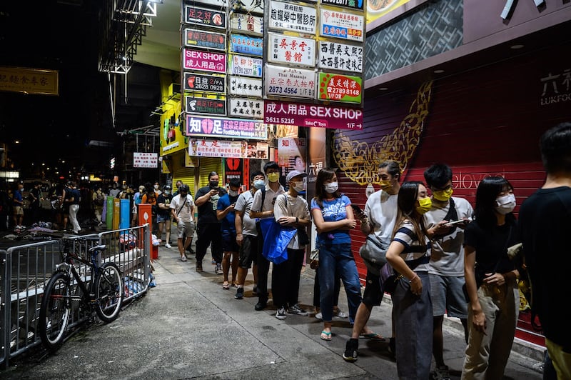 People queue for the last edition of the Apple Daily newspaper in Hong Kong early on June 24, 2021. Credit: AFP