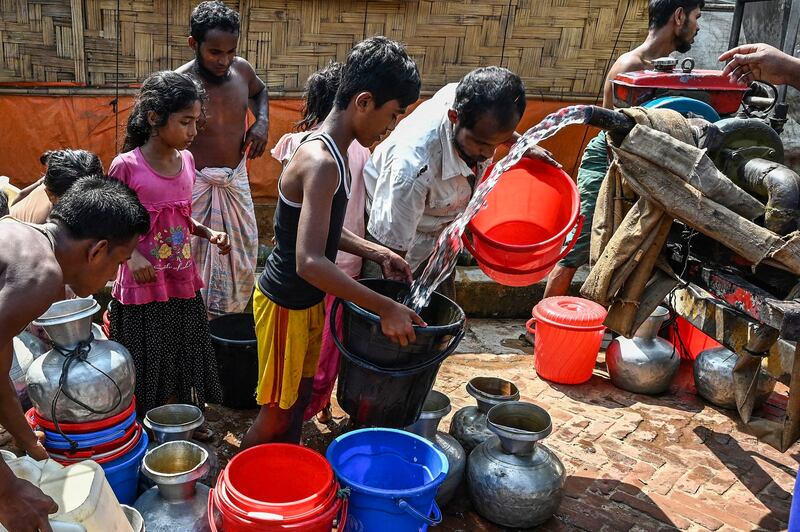 Rohingya refugees collect drinking water in the Kutupalong refugee camp in Ukhia, Bangladesh, Sept. 29, 2022. Credit: AFP