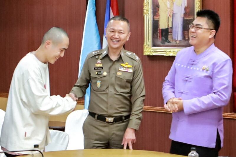 Chinese actor Wang Xing, left, shakes the hand of a Thai police officer after being released from a Myanmar scam center, in Thailand’s Mae Sot district, Jan. 7, 2025.