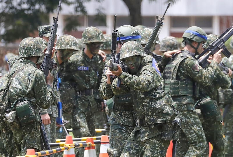 Taiwanese soldiers hold firearms in a military training as Taiwan President Lai Ching-te, not in photo, inspects the Taiwanese military in Taichung, Central Taiwan, Friday, June 28, 2024.